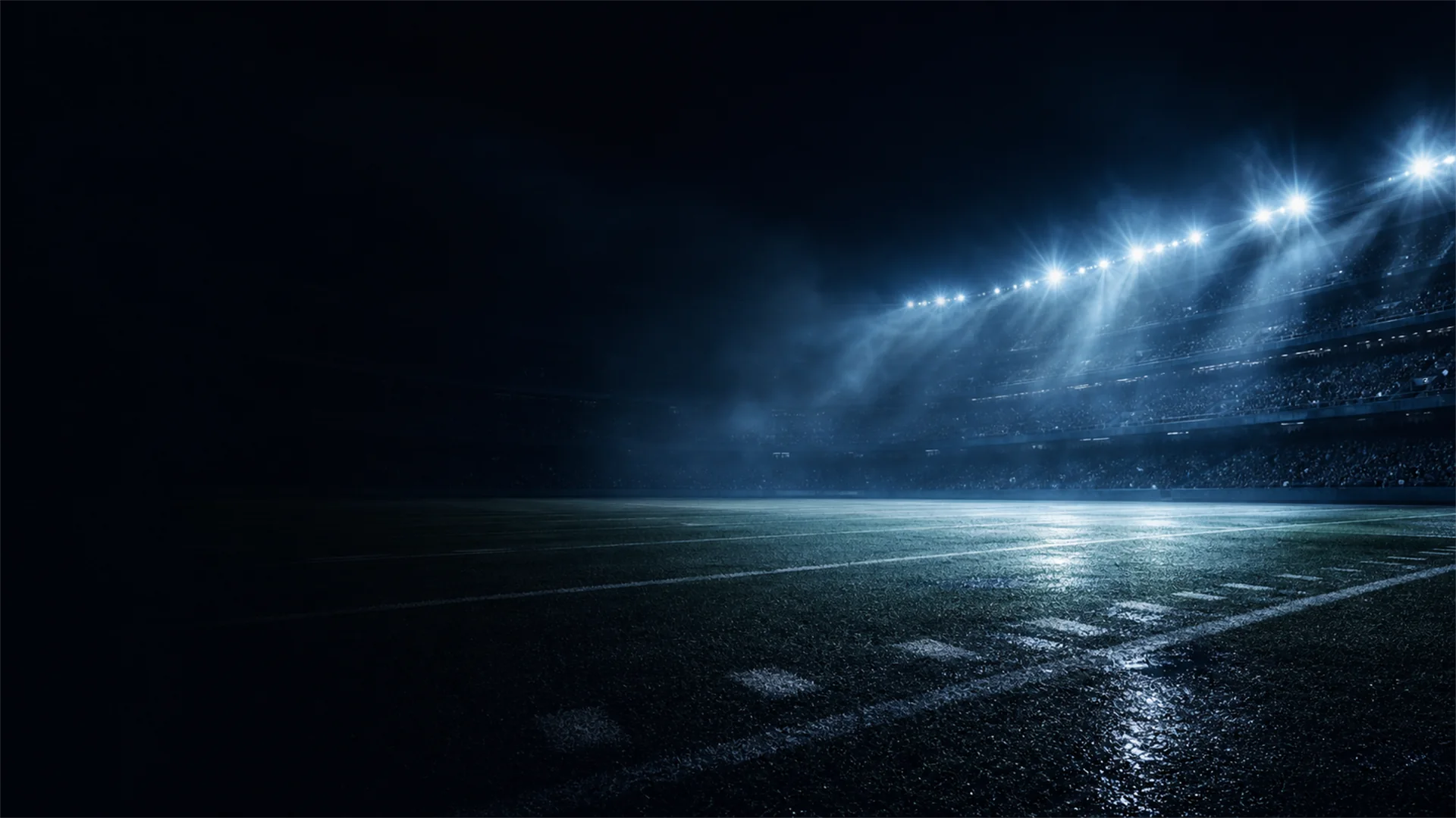 A night stadium illuminated through blue haze